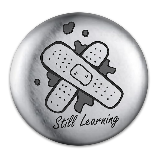 Still Learning Tat Engraved Button